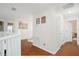 Upstairs hallway with wood floors featuring comic-themed decor at 8404 Secret Key Cv, Kissimmee, FL 34747