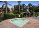 Community hot tub surrounded by lush greenery and lounge chairs for relaxing at 8404 Secret Key Cv, Kissimmee, FL 34747