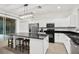 Spacious kitchen featuring modern appliances, island with seating, black granite countertops and white cabinets at 8404 Secret Key Cv, Kissimmee, FL 34747