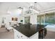 The kitchen island offers seating and views of the pool in this open-concept living space at 8404 Secret Key Cv, Kissimmee, FL 34747