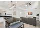 Bright, open-concept living space with a kitchen island, a modern light fixture, and a high ceiling at 8404 Secret Key Cv, Kissimmee, FL 34747