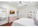 The bright main bedroom offers a television, soft decor, and an ensuite bathroom at 8404 Secret Key Cv, Kissimmee, FL 34747