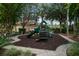 Community playground featuring green slides and play equipment in a mulch-covered area at 8404 Secret Key Cv, Kissimmee, FL 34747