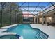 Inviting pool area surrounded by a screened enclosure with a jacuzzi for outdoor relaxation and entertainment at 8404 Secret Key Cv, Kissimmee, FL 34747