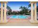 Resort-style community swimming pool with brick trim and framed by white columns at 8404 Secret Key Cv, Kissimmee, FL 34747