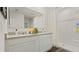 Modern bathroom with a double sink vanity, sleek countertops, and a shower with glass enclosure at 972 Fawn Grace Rd, Umatilla, FL 32784
