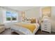Bright bedroom featuring large windows, stylish furnishings, and a comfortable bed with colorful pillows at 972 Fawn Grace Rd, Umatilla, FL 32784