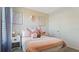Cozy bedroom with patterned wallpaper, a comfortable bed, and soft decor at 972 Fawn Grace Rd, Umatilla, FL 32784