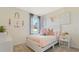 Adorable ' bedroom featuring soft colors, playful decor, and a cozy bed with decorative pillows at 972 Fawn Grace Rd, Umatilla, FL 32784
