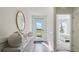 Bright foyer showcases a stylish mirror, elegant decor, and a view to the outside at 972 Fawn Grace Rd, Umatilla, FL 32784