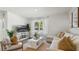 Comfortable living room with sectional sofa, large TV, and natural light at 972 Fawn Grace Rd, Umatilla, FL 32784