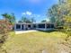 A sprawling backyard features a screened-in porch and a well-maintained lawn for outdoor enjoyment at 1228 Vantage Dr, Orlando, FL 32806
