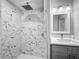 Modern bathroom featuring a shower with decorative tile, vanity, and updated fixtures at 1228 Vantage Dr, Orlando, FL 32806