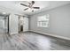 Bedroom with a ceiling fan, window, and a sliding barn door to the bathroom at 1228 Vantage Dr, Orlando, FL 32806
