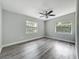 Spacious bedroom with neutral paint, two windows for great lighting, and hard-surface floors at 1228 Vantage Dr, Orlando, FL 32806