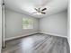 Bright bedroom featuring wood-look floors, a ceiling fan and plenty of natural light at 1228 Vantage Dr, Orlando, FL 32806