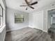 Bedroom featuring modern ceiling fan, neutral paint, wood-look floors, closet and natural light at 1228 Vantage Dr, Orlando, FL 32806