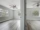 This bedroom is bright and airy with wood-look floors and a view of the lush landscaping at 1228 Vantage Dr, Orlando, FL 32806