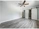 Spacious bedroom featuring wood-look floors, ceiling fan, ensuite bathroom and closet at 1228 Vantage Dr, Orlando, FL 32806