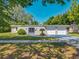 Welcoming home featuring a well-kept lawn, enclosed yard, and an attached two-car garage at 1228 Vantage Dr, Orlando, FL 32806