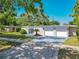 Home featuring a well-manicured lawn, a secure gate, and an attached two-car garage at 1228 Vantage Dr, Orlando, FL 32806