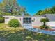 Attractive house features a secure gate, well-kept lawn, and an attached garage with two doors at 1228 Vantage Dr, Orlando, FL 32806