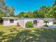 Single-story home with a well-kept lawn, gated entry, and drought-tolerant landscaping at 1228 Vantage Dr, Orlando, FL 32806