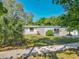 Single-story home with a gated entry, mature landscaping, and a tidy front lawn at 1228 Vantage Dr, Orlando, FL 32806