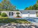 Inviting single-story home featuring a gated entrance, easy access two-car garage, and blue driveway at 1228 Vantage Dr, Orlando, FL 32806