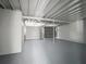 Spacious garage with high ceilings, and painted floors and walls at 1228 Vantage Dr, Orlando, FL 32806