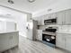 Bright kitchen featuring new appliances, gray cabinets, and new countertops at 1228 Vantage Dr, Orlando, FL 32806