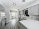 Beautifully renovated kitchen with gray cabinetry, modern backsplash, and stainless steel appliances at 1228 Vantage Dr, Orlando, FL 32806