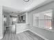 Updated kitchen with gray cabinets, quartz countertops, and a breakfast bar overlooking the adjacent living area at 1228 Vantage Dr, Orlando, FL 32806