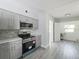 Modern kitchen featuring stainless steel appliances, gray cabinets, and an open layout at 1228 Vantage Dr, Orlando, FL 32806