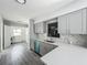 Bright kitchen with gray cabinets, stainless steel sink, and marble-patterned backsplash at 1228 Vantage Dr, Orlando, FL 32806