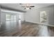 Modern living area featuring stylish gray floors, natural light, and a view of the landscaped front yard at 1228 Vantage Dr, Orlando, FL 32806