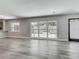 Spacious living area with new wood flooring, gray walls, and a large window overlooking the backyard at 1228 Vantage Dr, Orlando, FL 32806