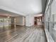 Large living room area featuring wood flooring, gray walls, and multiple windows at 1228 Vantage Dr, Orlando, FL 32806