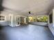 View of the patio with a ceiling fan and glass windows, ample lighting and space at 1228 Vantage Dr, Orlando, FL 32806