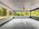 Enclosed patio with white block walls and ample lighting, plus views of backyard landscaping at 1228 Vantage Dr, Orlando, FL 32806