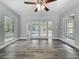 Sunroom features gray flooring, abundant natural light, and a ceiling fan for added comfort at 1228 Vantage Dr, Orlando, FL 32806