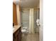Bathroom featuring a shower-tub combo with tiled floors, toilet, and granite sink top at 12527 Floridays Resort Dr # 311E, Orlando, FL 32821