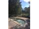 Relaxing outdoor hot tub surrounded by mature trees in a fenced area at 12527 Floridays Resort Dr # 311E, Orlando, FL 32821