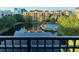 View of a relaxing pool area surrounded by lush landscaping and a tranquil lake at 12527 Floridays Resort Dr # 311E, Orlando, FL 32821