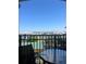 View from balcony shows a metal table and chair with a cityscape view in the background at 12527 Floridays Resort Dr # 603E, Orlando, FL 32821
