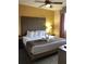 Inviting bedroom featuring a king-sized bed, warm lighting, and a view of the surrounding landscape at 12527 Floridays Resort Dr # 603E, Orlando, FL 32821