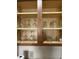 Interior view of kitchen cabinet showing glassware neatly arranged on shelves at 12527 Floridays Resort Dr # 603E, Orlando, FL 32821