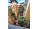 Exterior courtyard view of multi-story buildings with tropical landscaping and walking paths at 12527 Floridays Resort Dr # 603E, Orlando, FL 32821