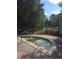 Relaxing hot tub with jets surrounded by lush landscaping and partial view of resort buildings at 12527 Floridays Resort Dr # 603E, Orlando, FL 32821