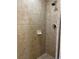 Tiled shower stall featuring neutral-toned tiles, shower head, and simple soap dish at 12527 Floridays Resort Dr # 603E, Orlando, FL 32821